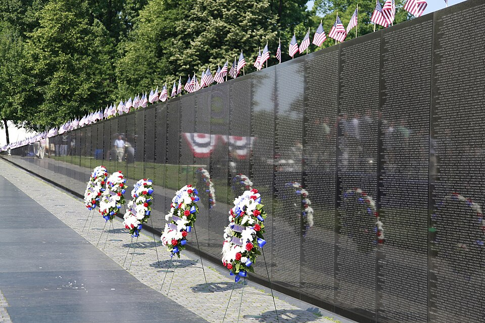 Vietnam Veterans Memorial wall with wreaths and American flags